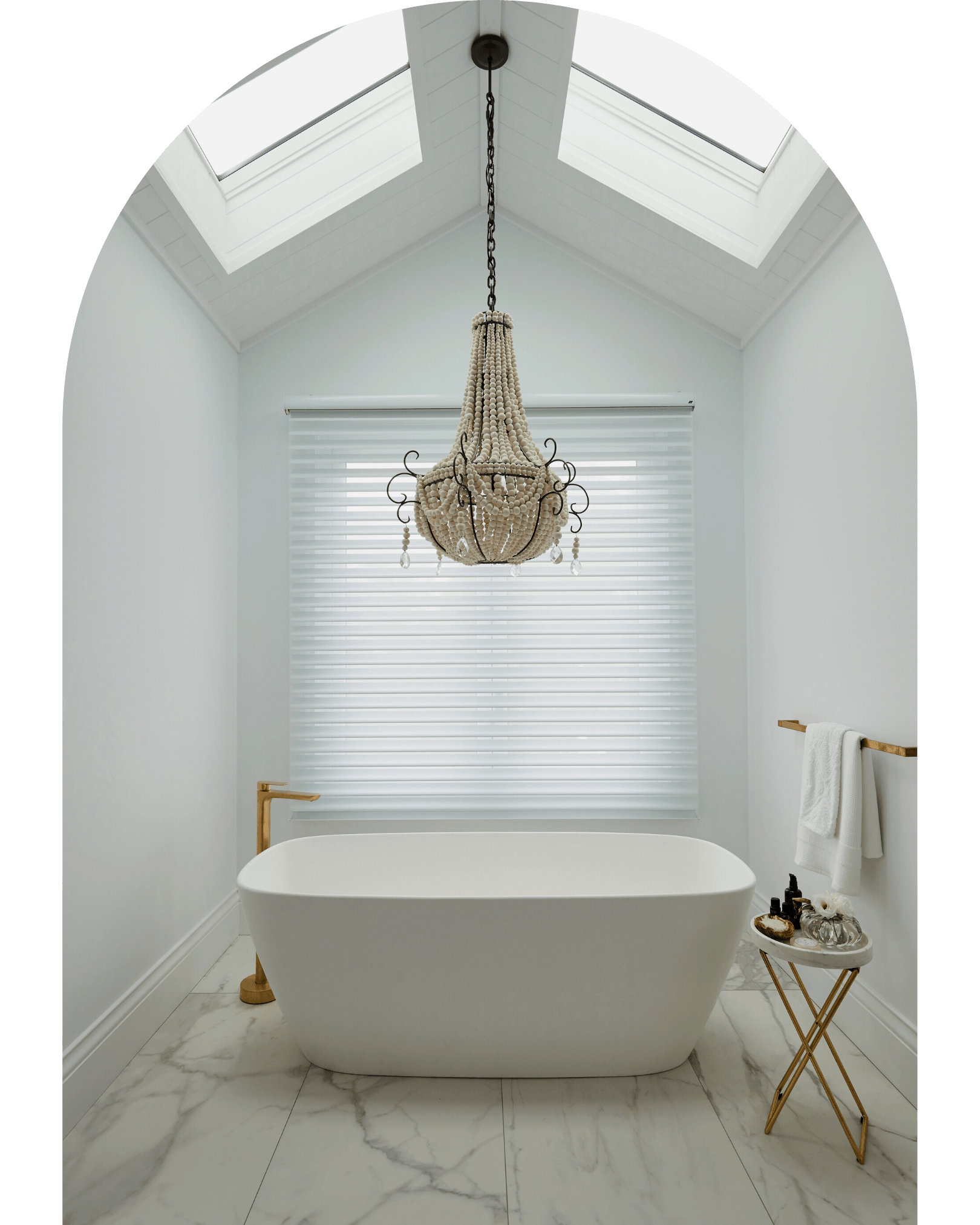 A bathroom with a bathtub and a chandelier hanging from the ceiling.