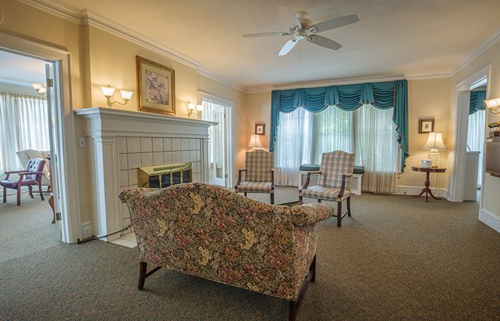 A room with a dresser and a picture on the wall.