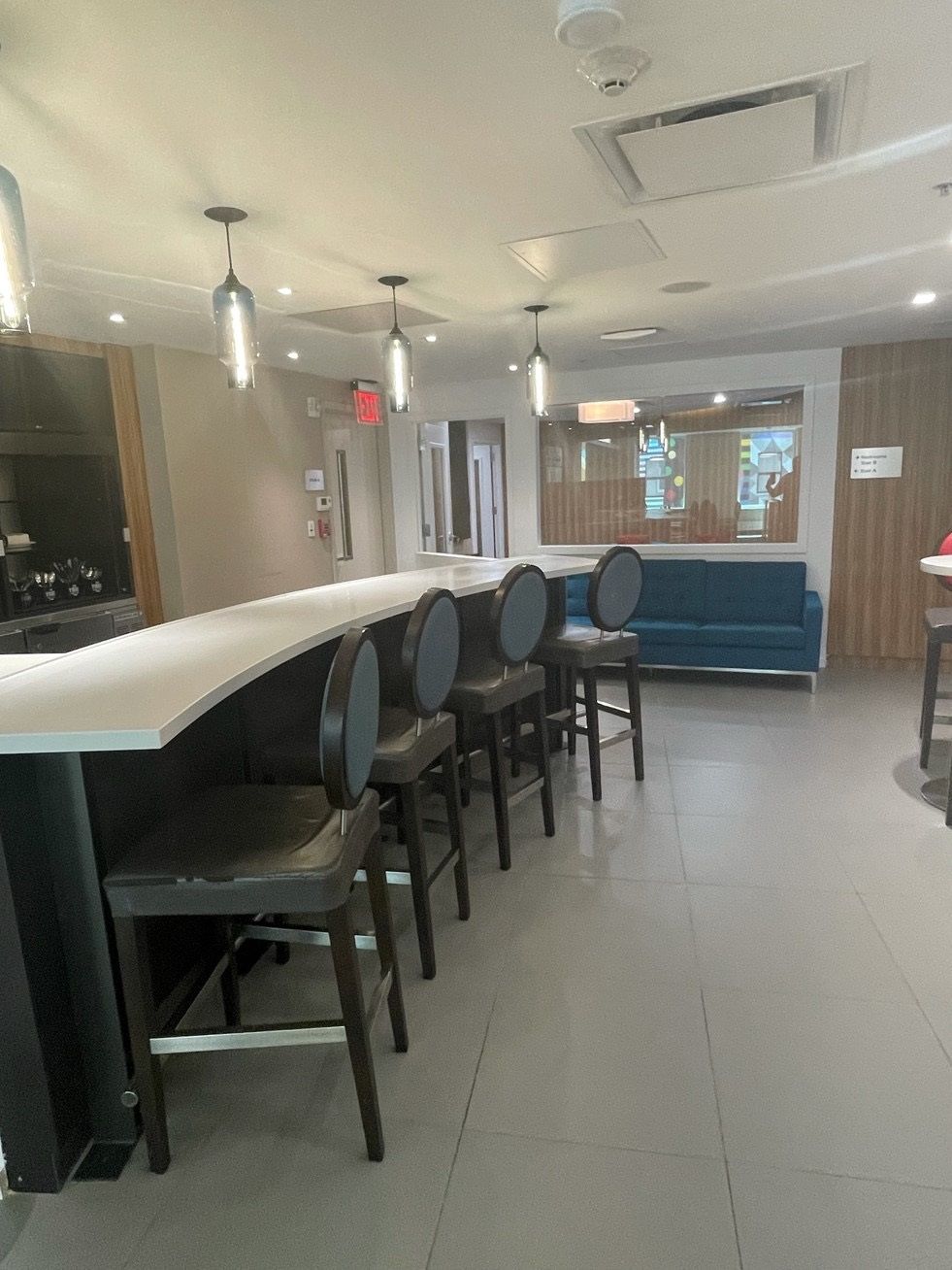 A room with a long table and chairs in it.