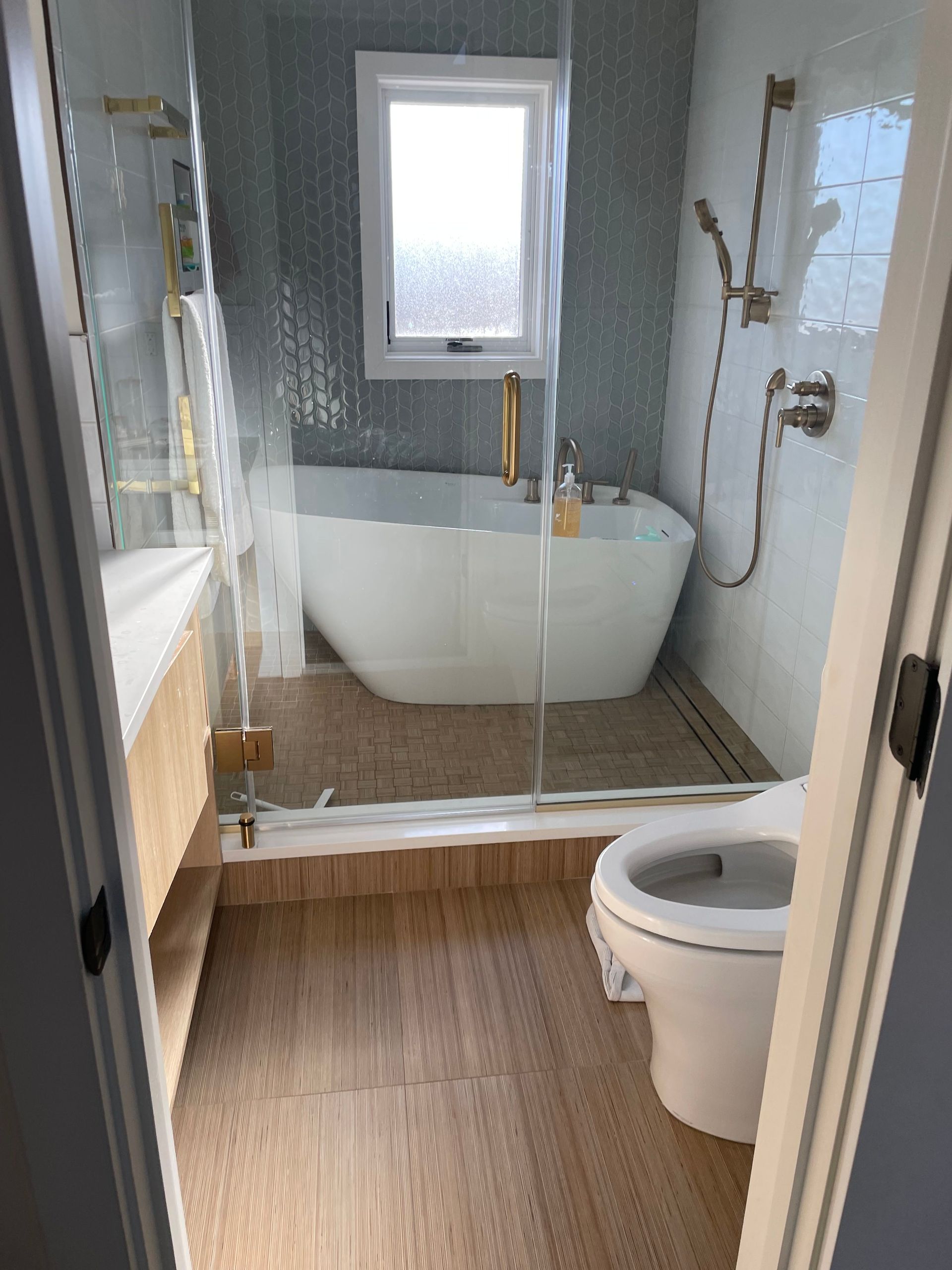 A bathroom with a tub , toilet and shower.
