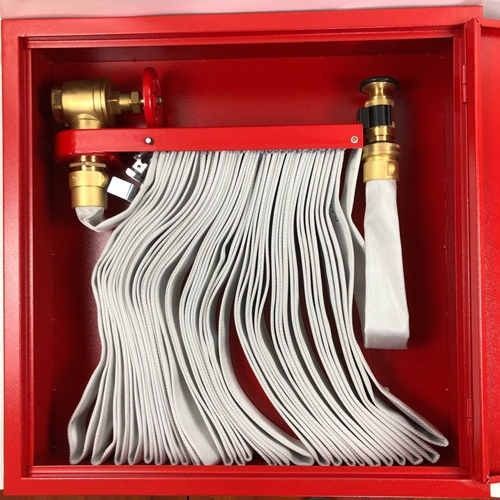 A red fire hose is hanging on a wall