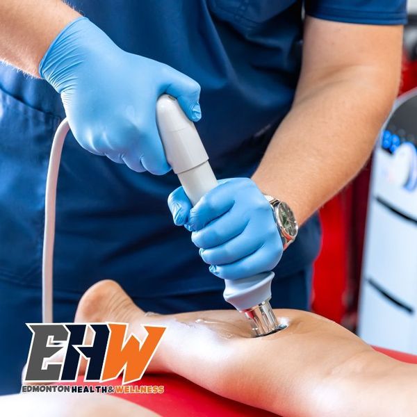 A patient getting shockwave treatment to the back of their calf