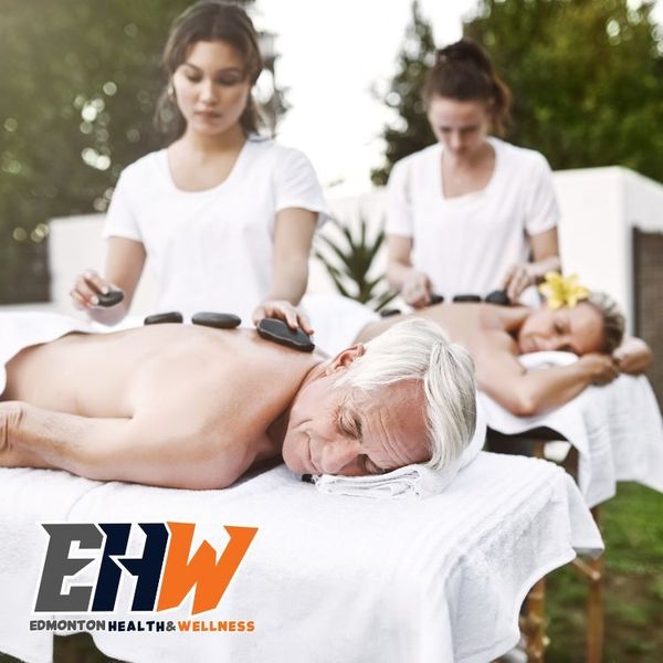 Eldery man and women, in the middle of their outdoor hot stone massage provided by our mobile massage therapists