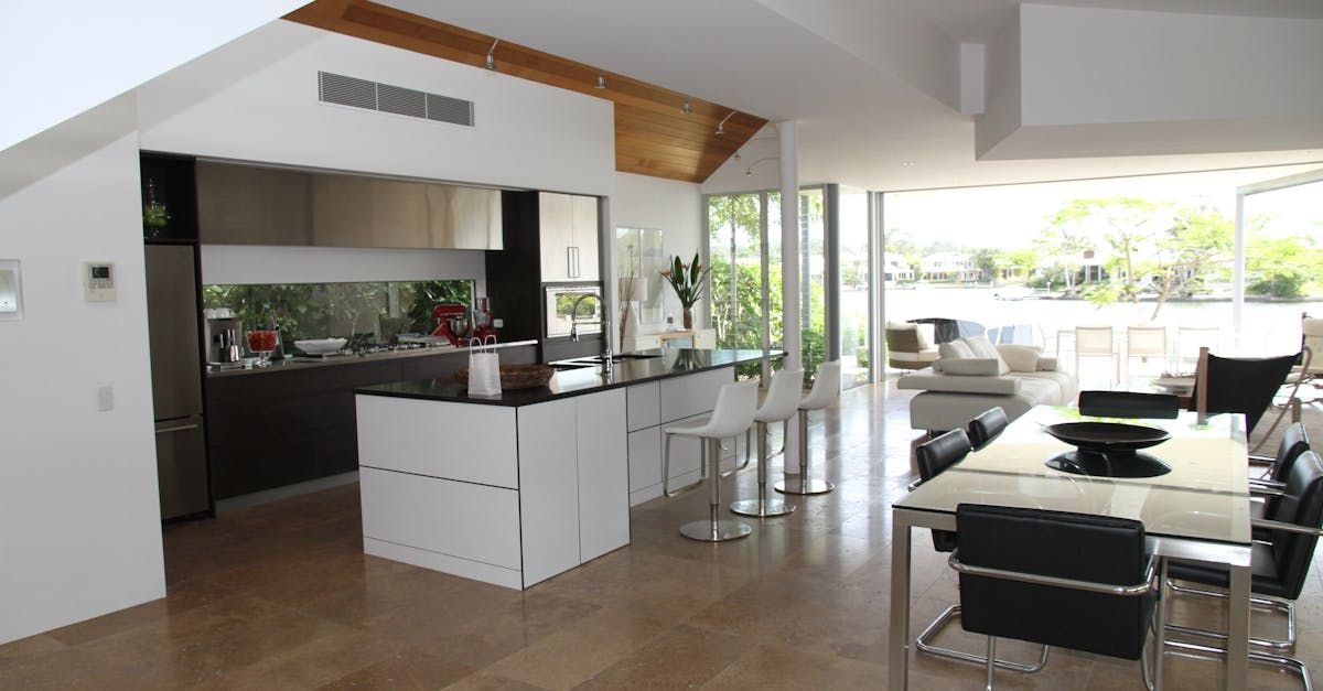 A kitchen and dining room in a house with a table and chairs.