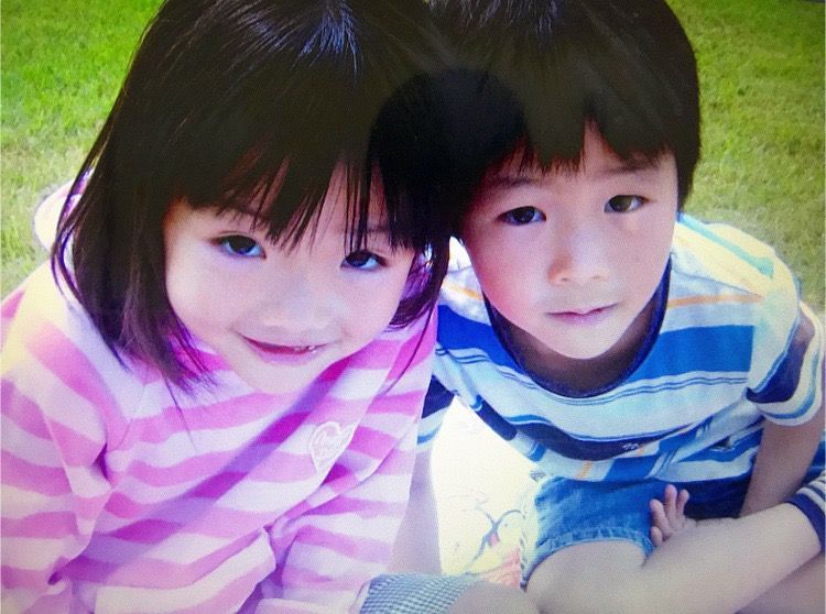 A boy and a girl are posing for a picture together
