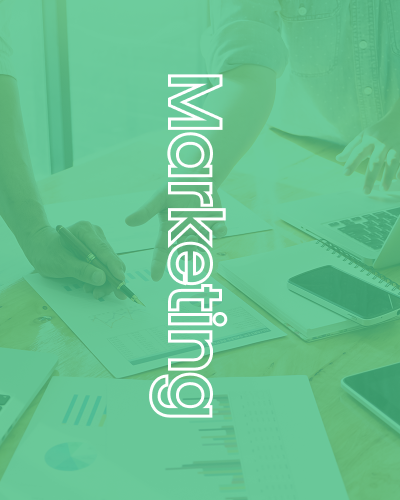 People collaborating around a table with papers, phones, and a laptop; green filter with 