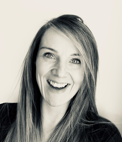 Woman with long hair smiles, close-up, black and white photo.
