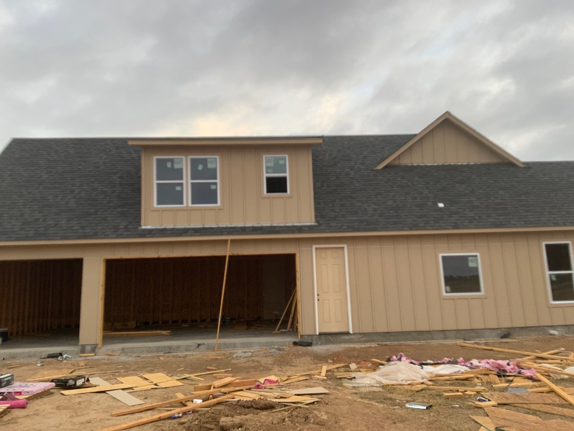 A house under construction with a gray roof