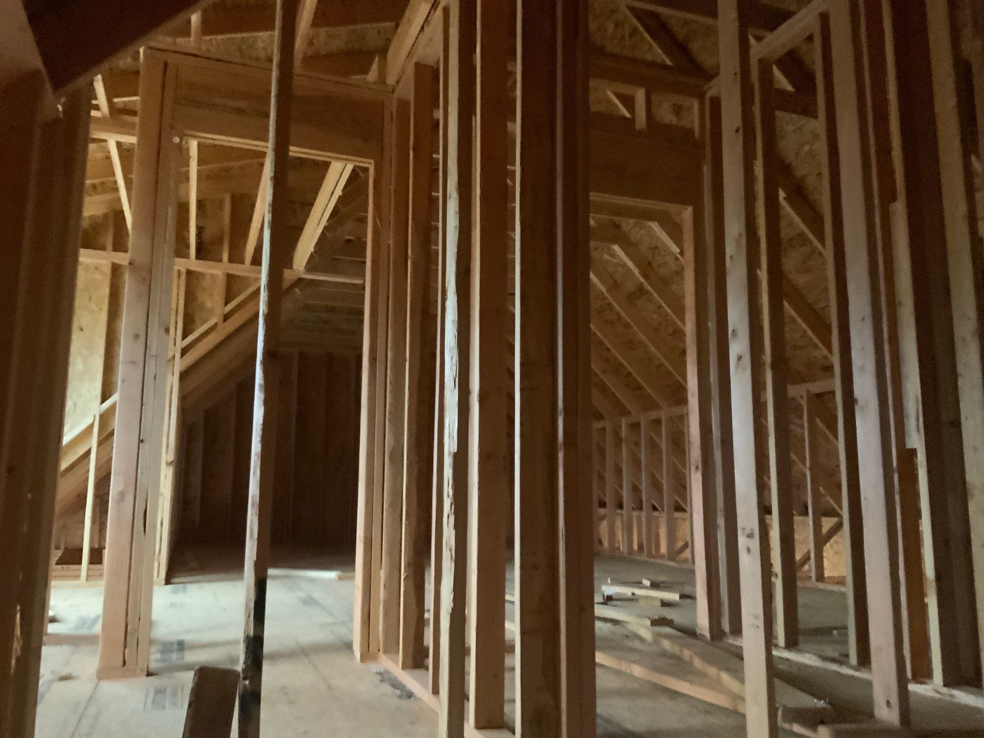 The inside of a building under construction with wooden beams.