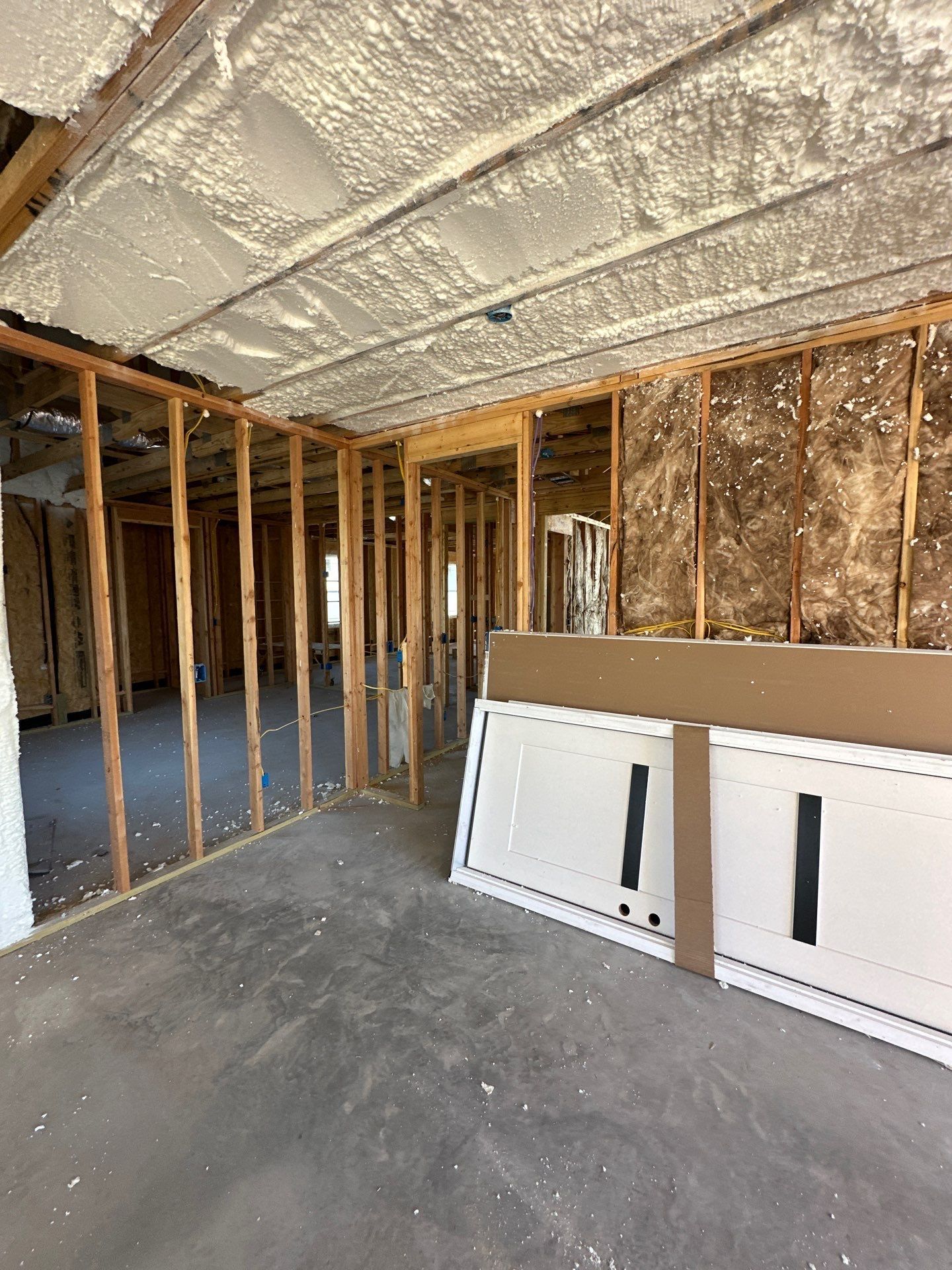 A room in a house under construction with foam on the ceiling.
