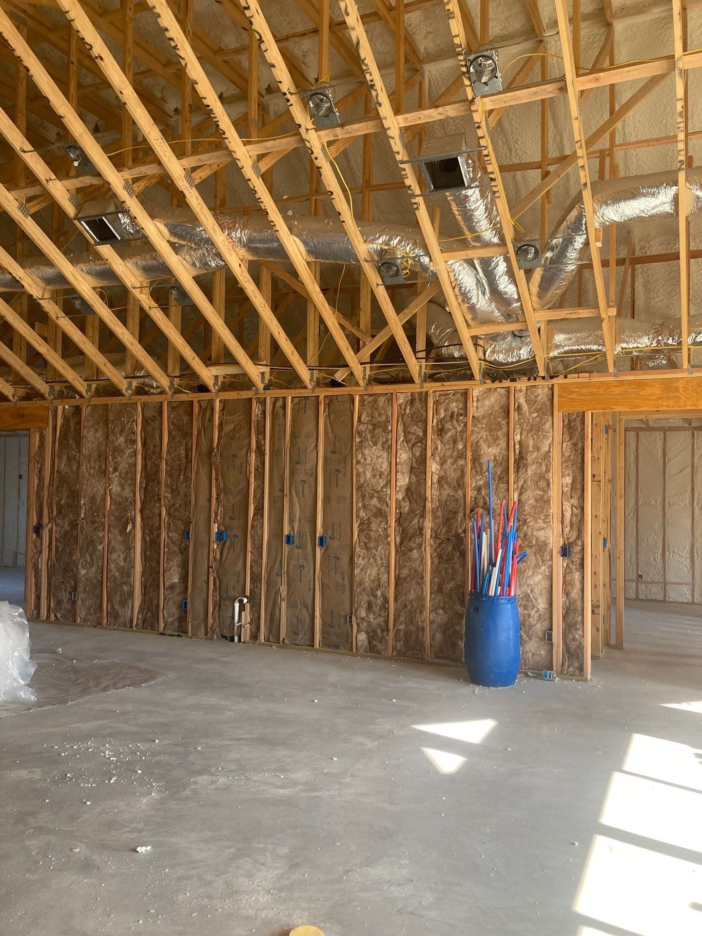 There is a blue barrel in the middle of the room.