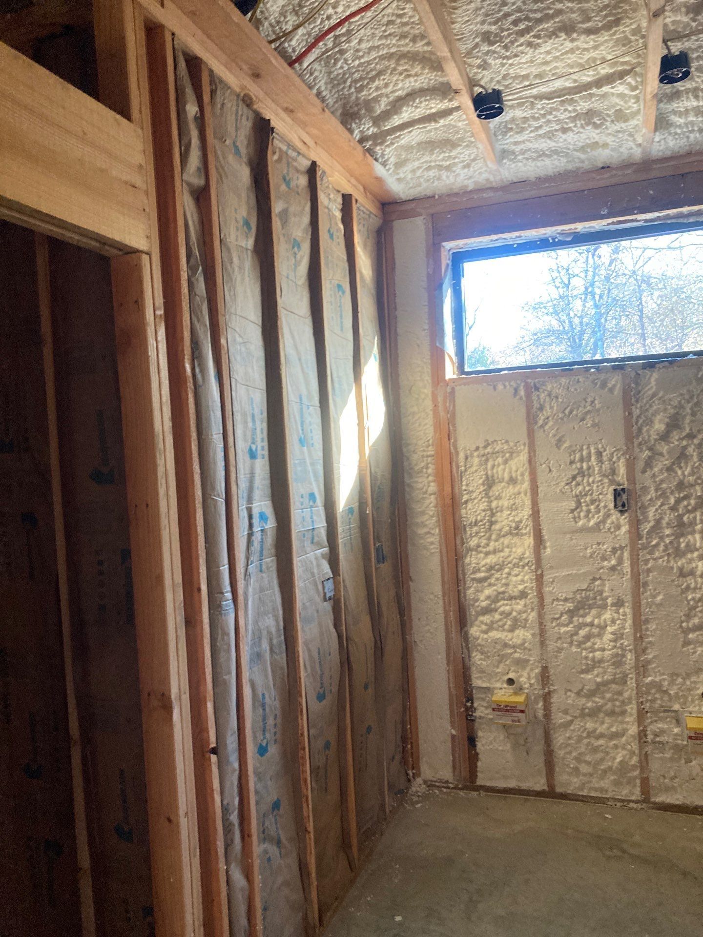 A room with foam insulation on the walls and ceiling.