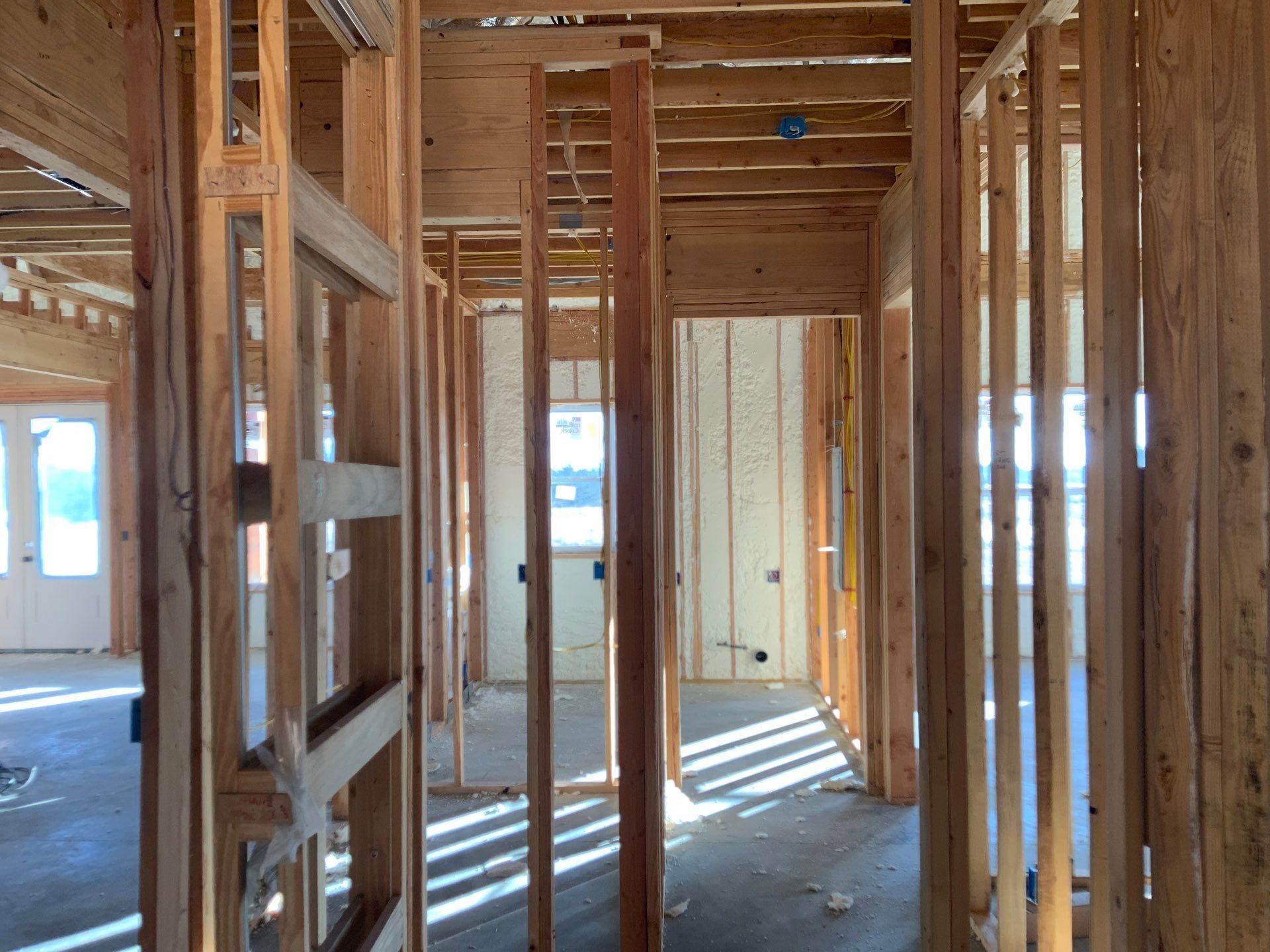The inside of a house being built with wooden beams