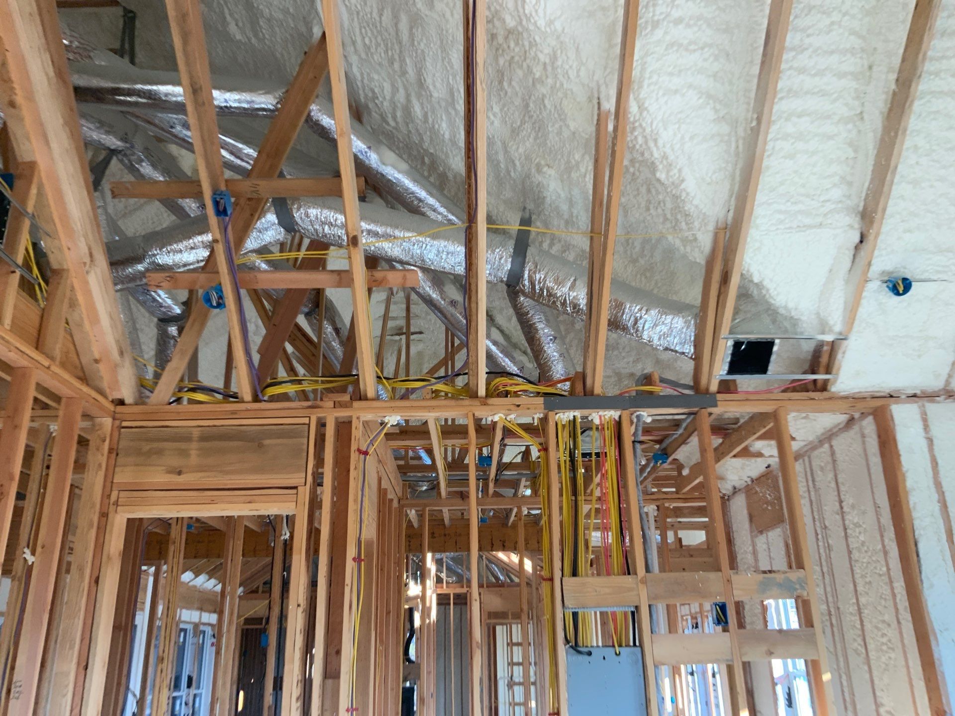 A house is being built with a lot of wood and foam on the ceiling.