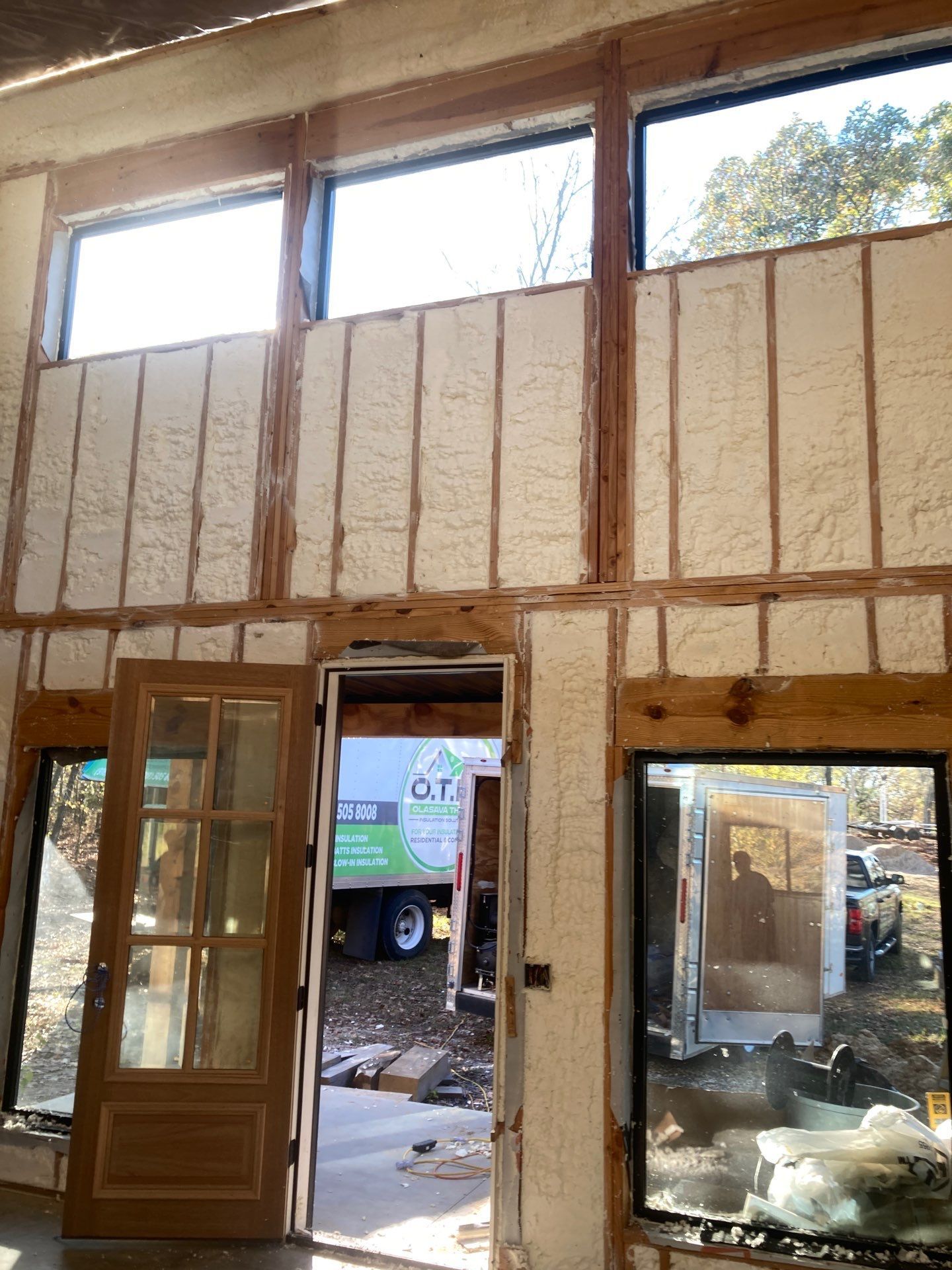 A room with a lot of windows and a door.