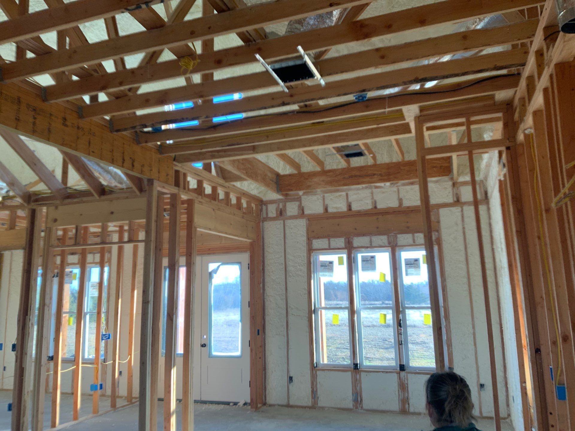 A person is standing in a room that is being built