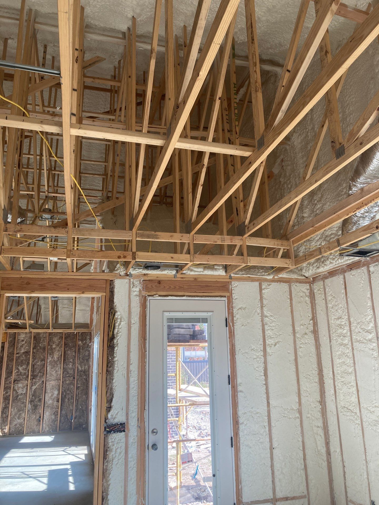 A room with a door and a ceiling that is being built.