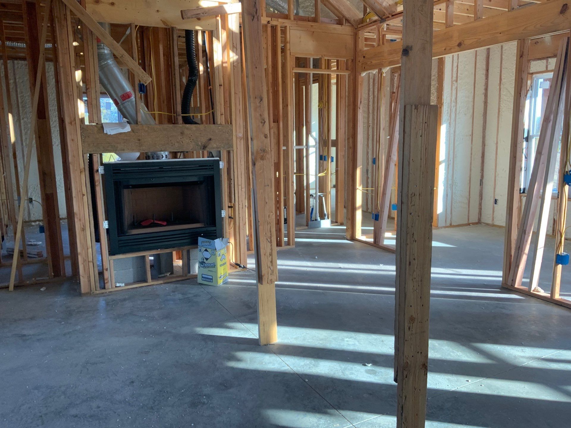 An empty room with a fireplace in the middle of it