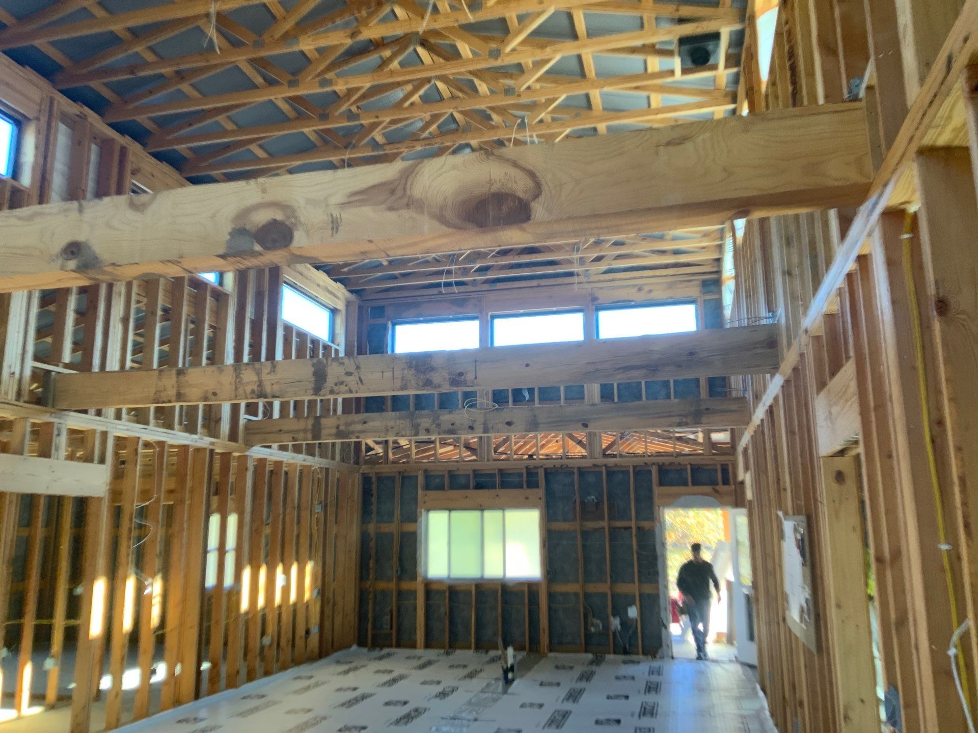 A man is walking through a house that is being built