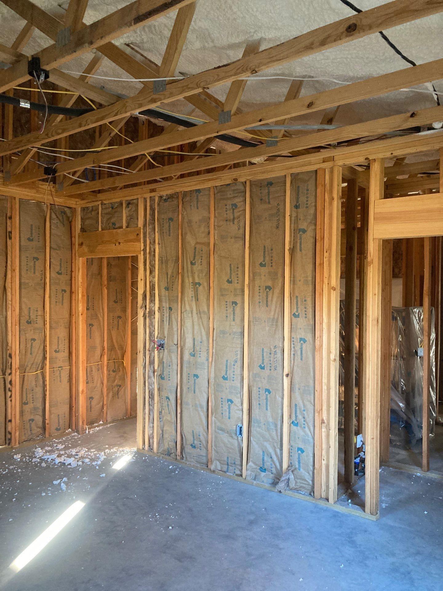 A room with a lot of wooden beams and insulation on the walls