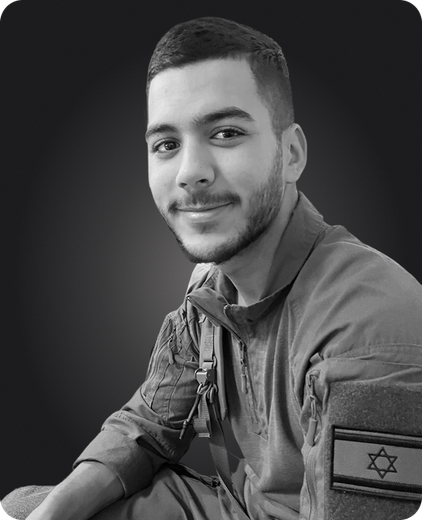 A black and white photo of a man in a military uniform with a star of david on his arm.