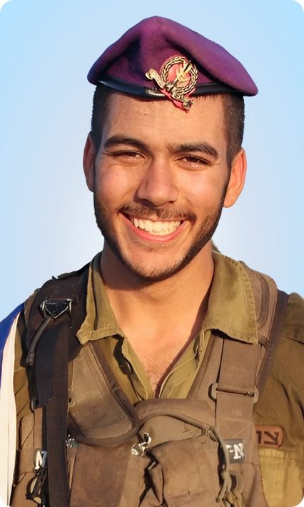 A man in a military uniform is smiling and wearing a purple hat