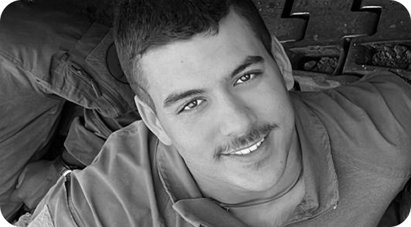 A man with a mustache is smiling in a black and white photo