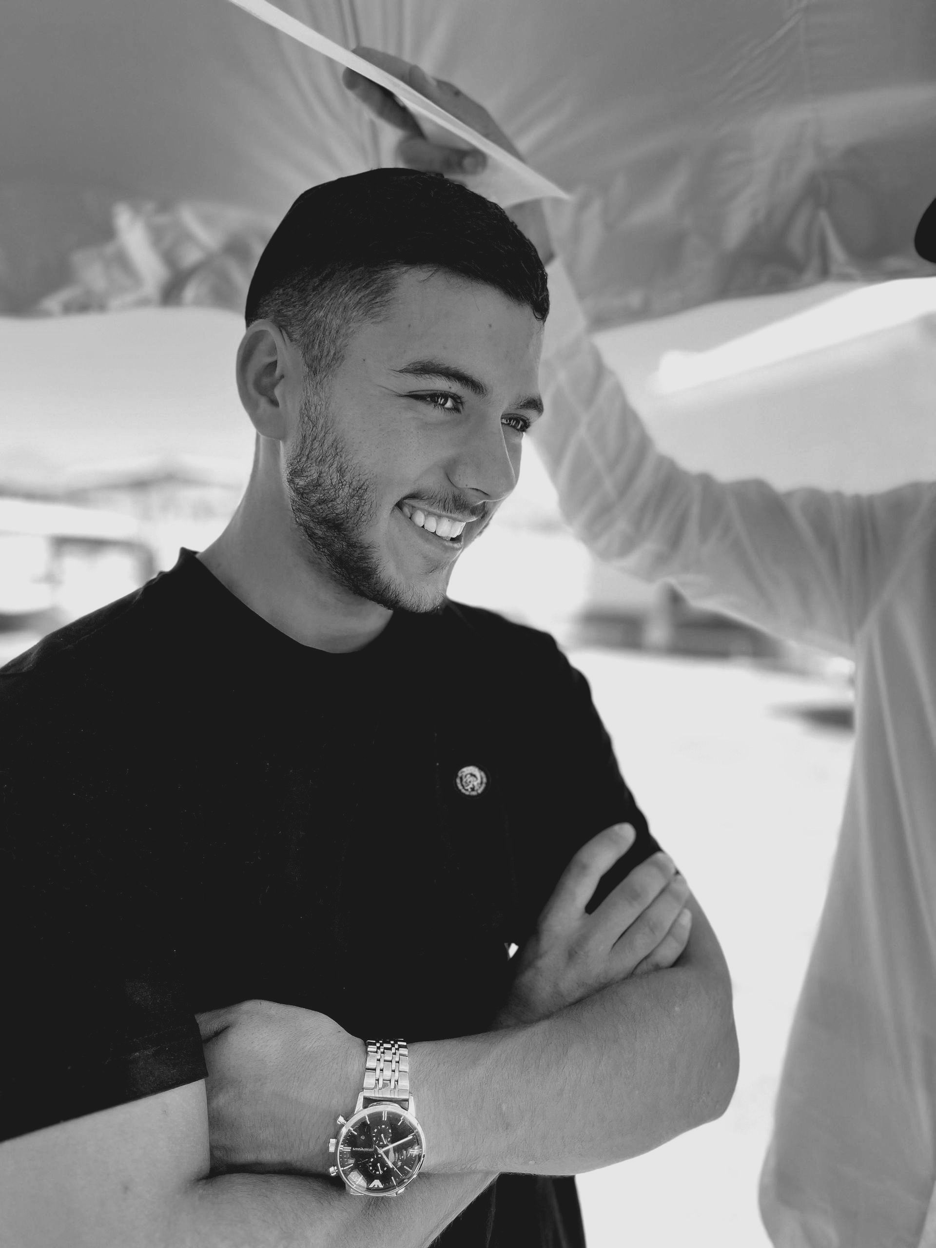 A black and white photo of a man wearing a watch