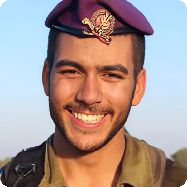 A man in a military uniform is smiling and wearing a purple hat.