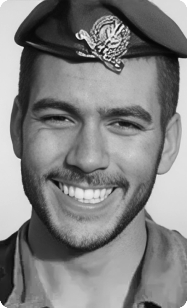 A black and white photo of a smiling man wearing a beret