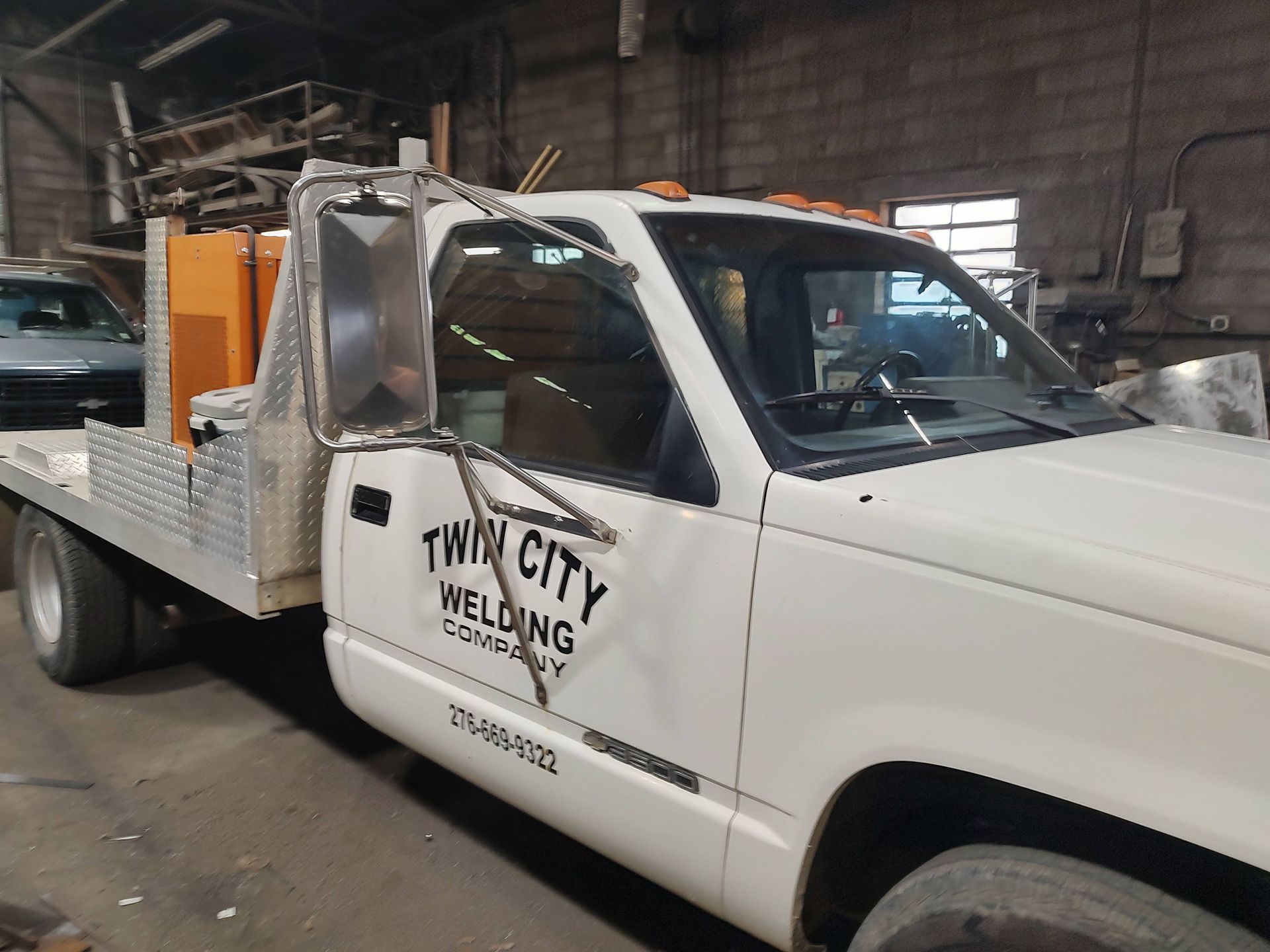 A white truck with twin city welding written on the side