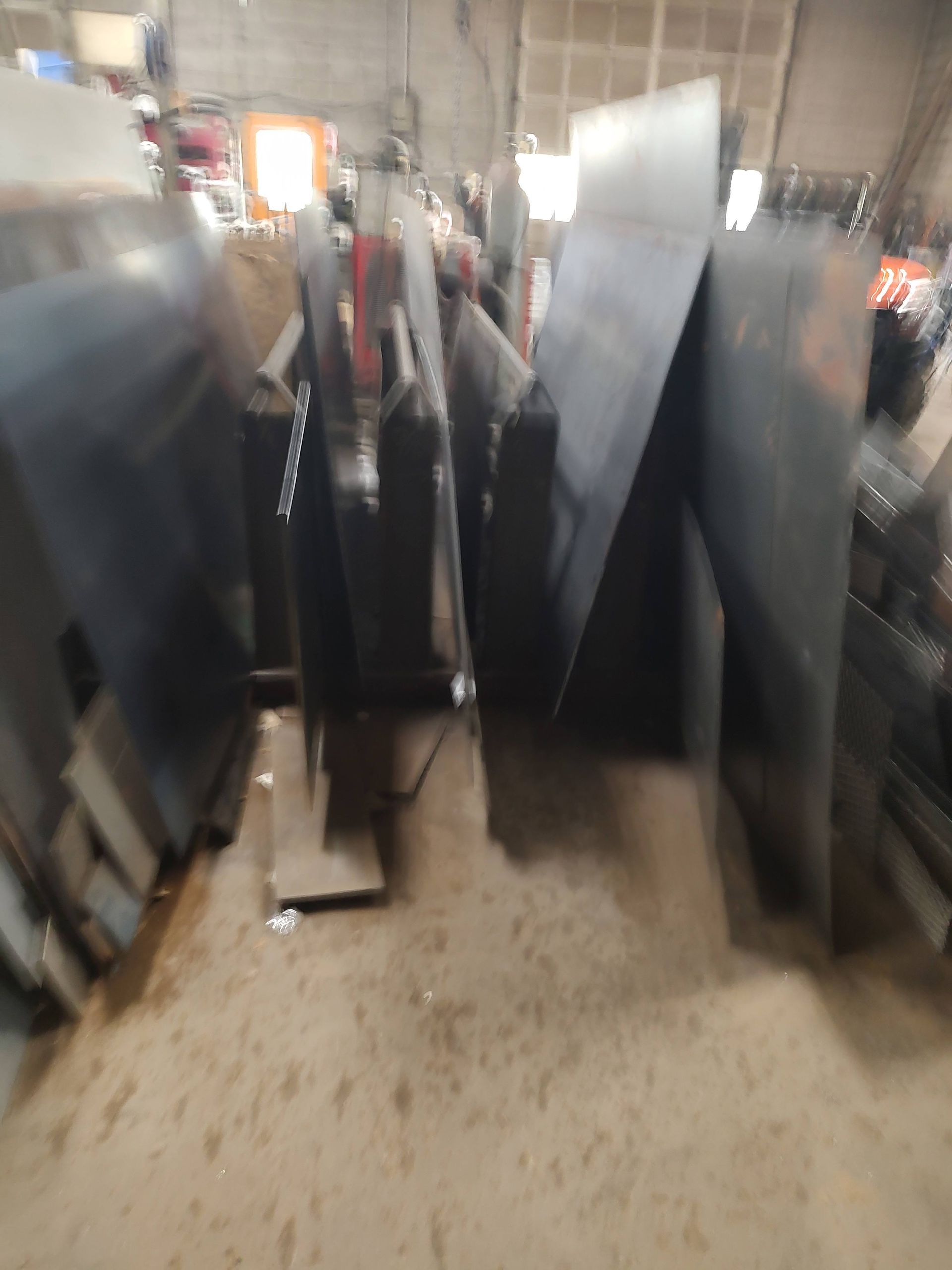 A bunch of pieces of metal are stacked on top of each other in a room.