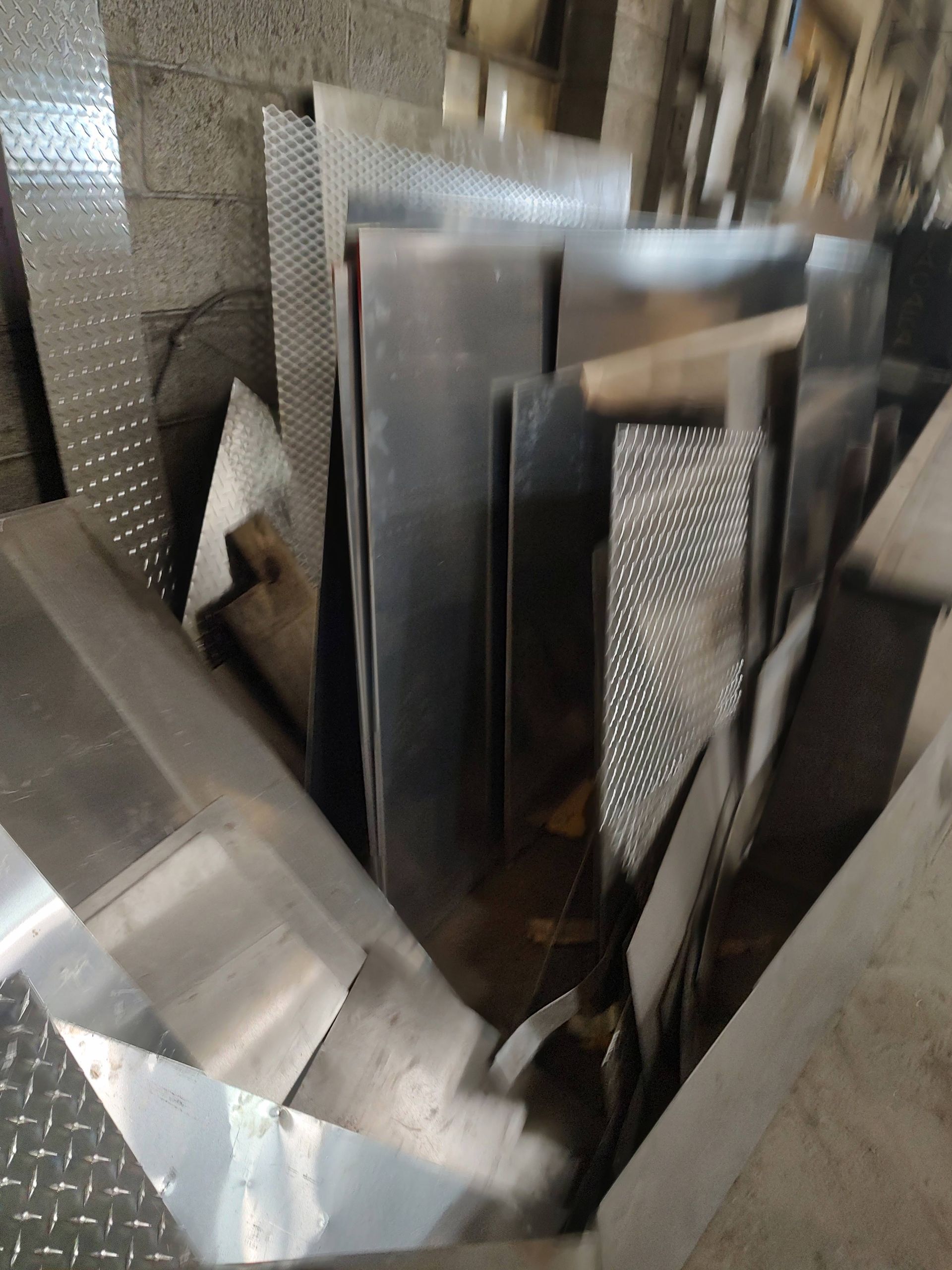 A pile of aluminum sheets stacked on top of each other