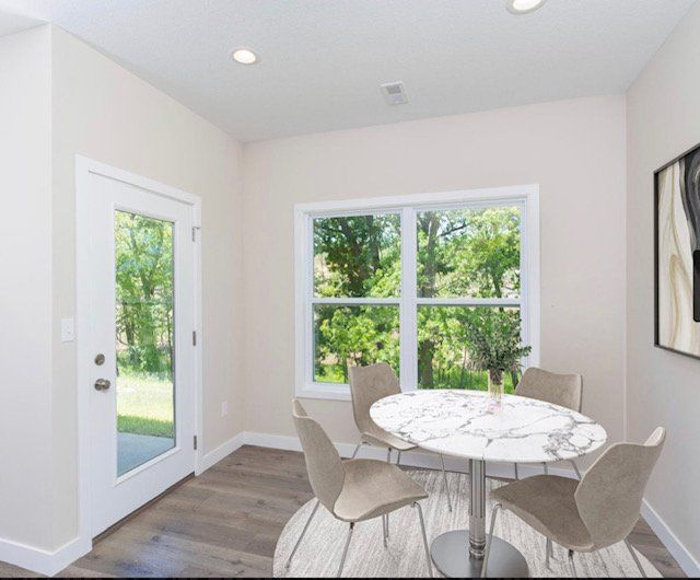 A dining room with a round table and chairs
