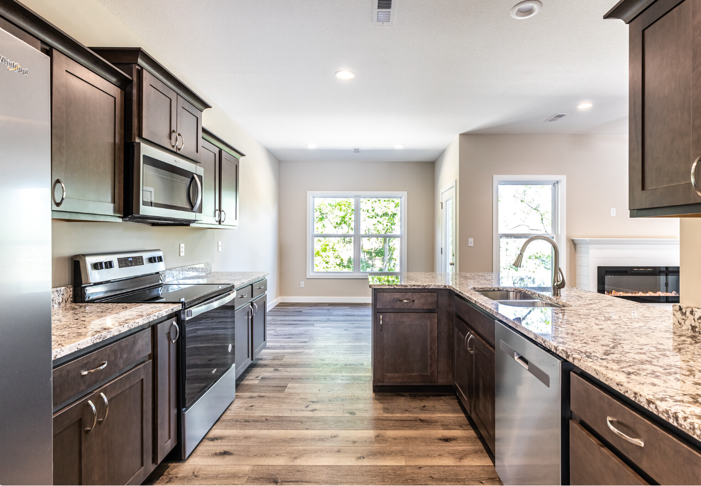 A kitchen with stainless steel appliances and granite counter tops.