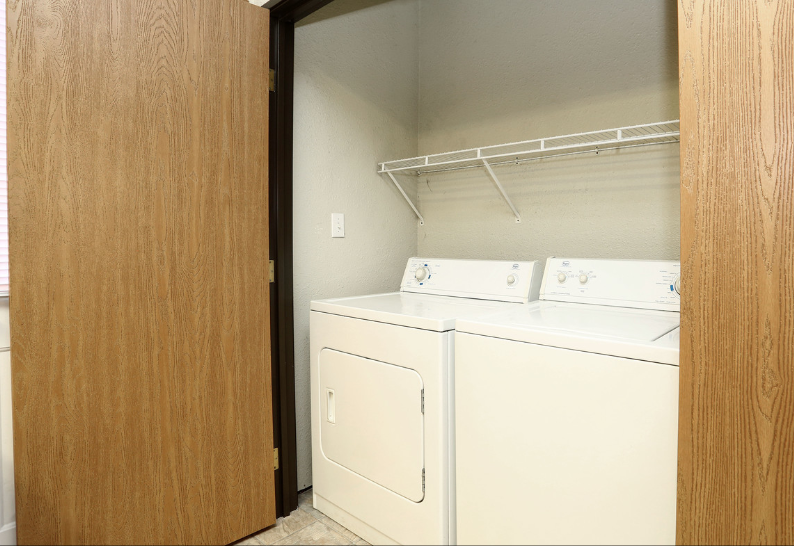 A laundry room with a washer and dryer in a closet.