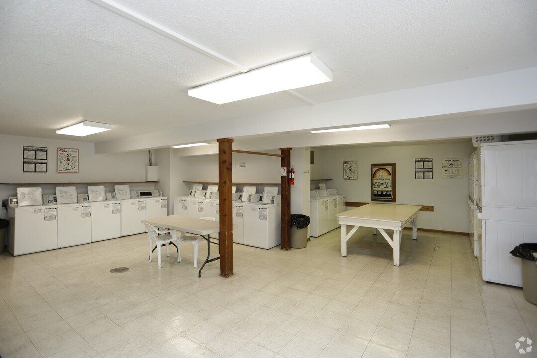 A laundromat with a table and a pool table