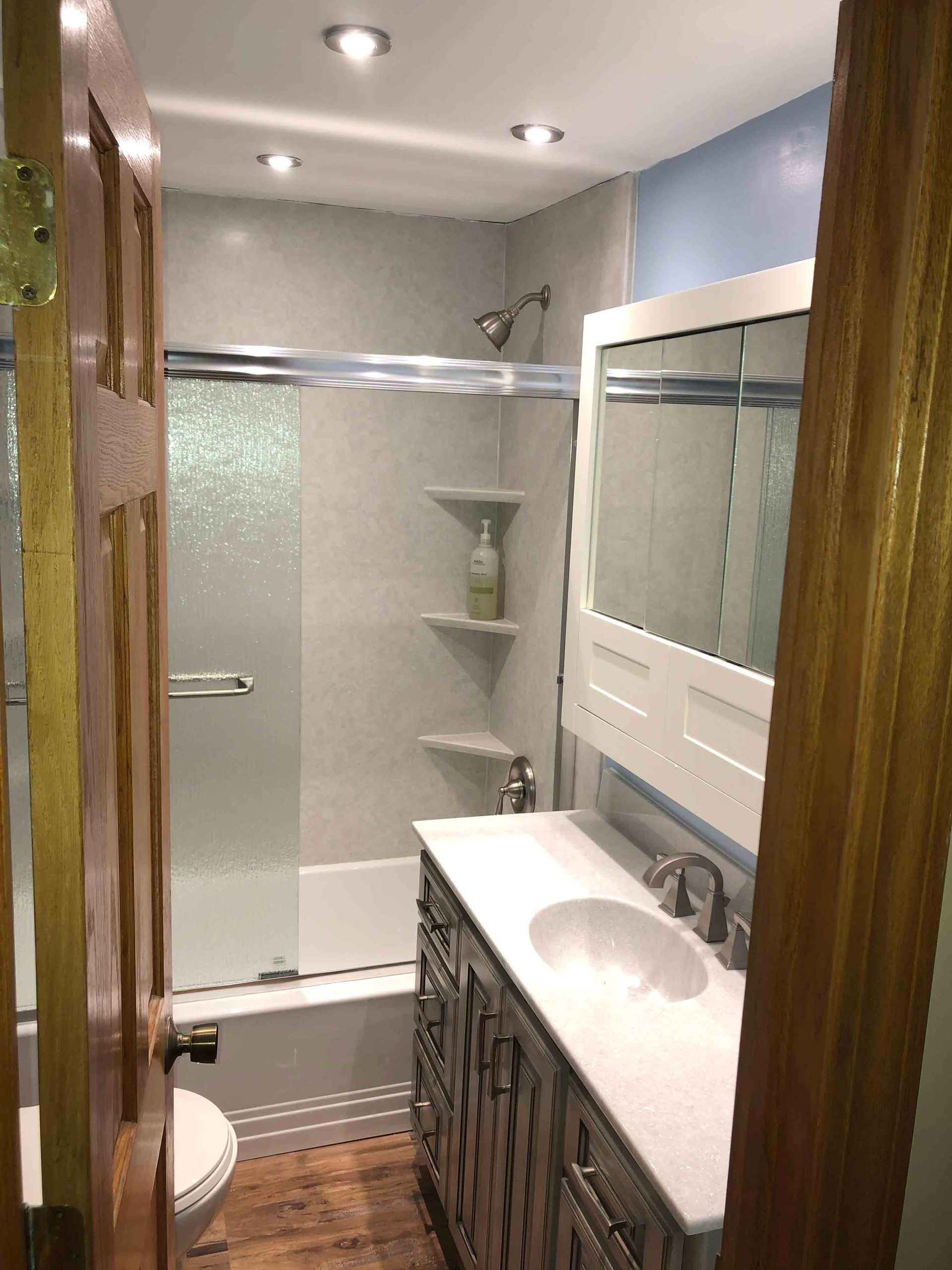 A Bathroom With A Shower And Sink — Laotto, IN — BathMan Bath Remodeling