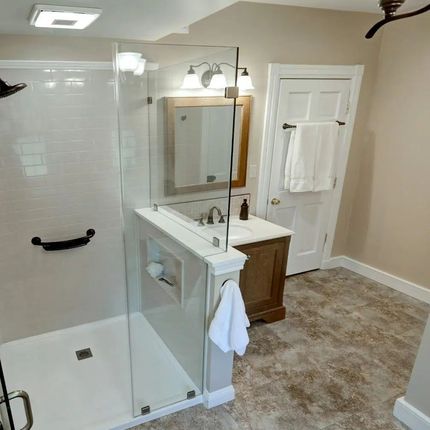 A Bathroom With Two Sinks And A Window — Laotto, IN — BathMan Bath Remodeling