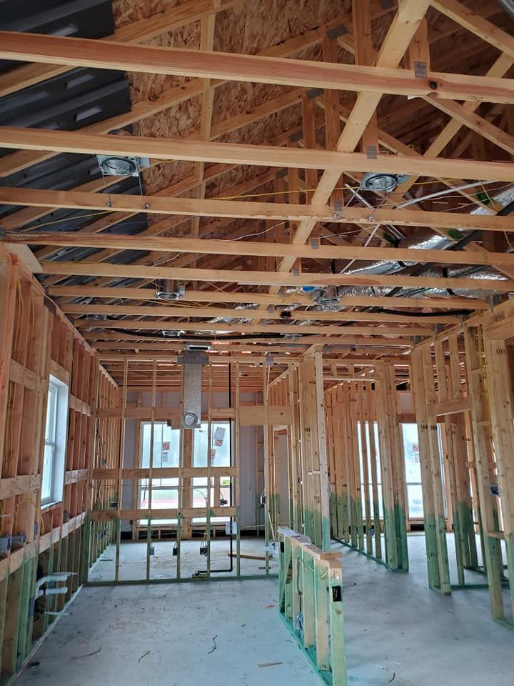 The inside of a building under construction with a lot of wooden beams.