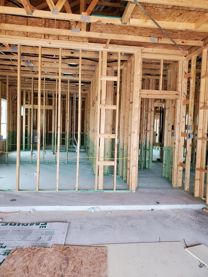 The inside of a house under construction with a lot of wooden beams.
