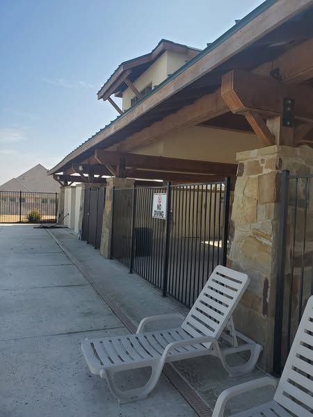 Two lounge chairs are sitting outside of a building