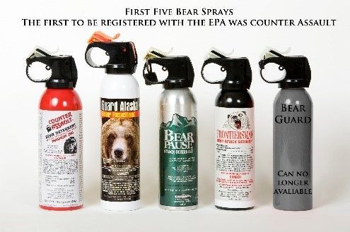 Five bear spray canisters lined up. Text says 