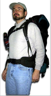 Man wearing a large backpack with a water bottle, light shirt, jeans, and a cap.