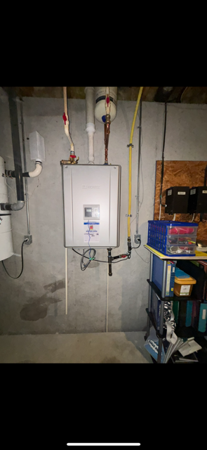 A picture of a water heater in a basement.
