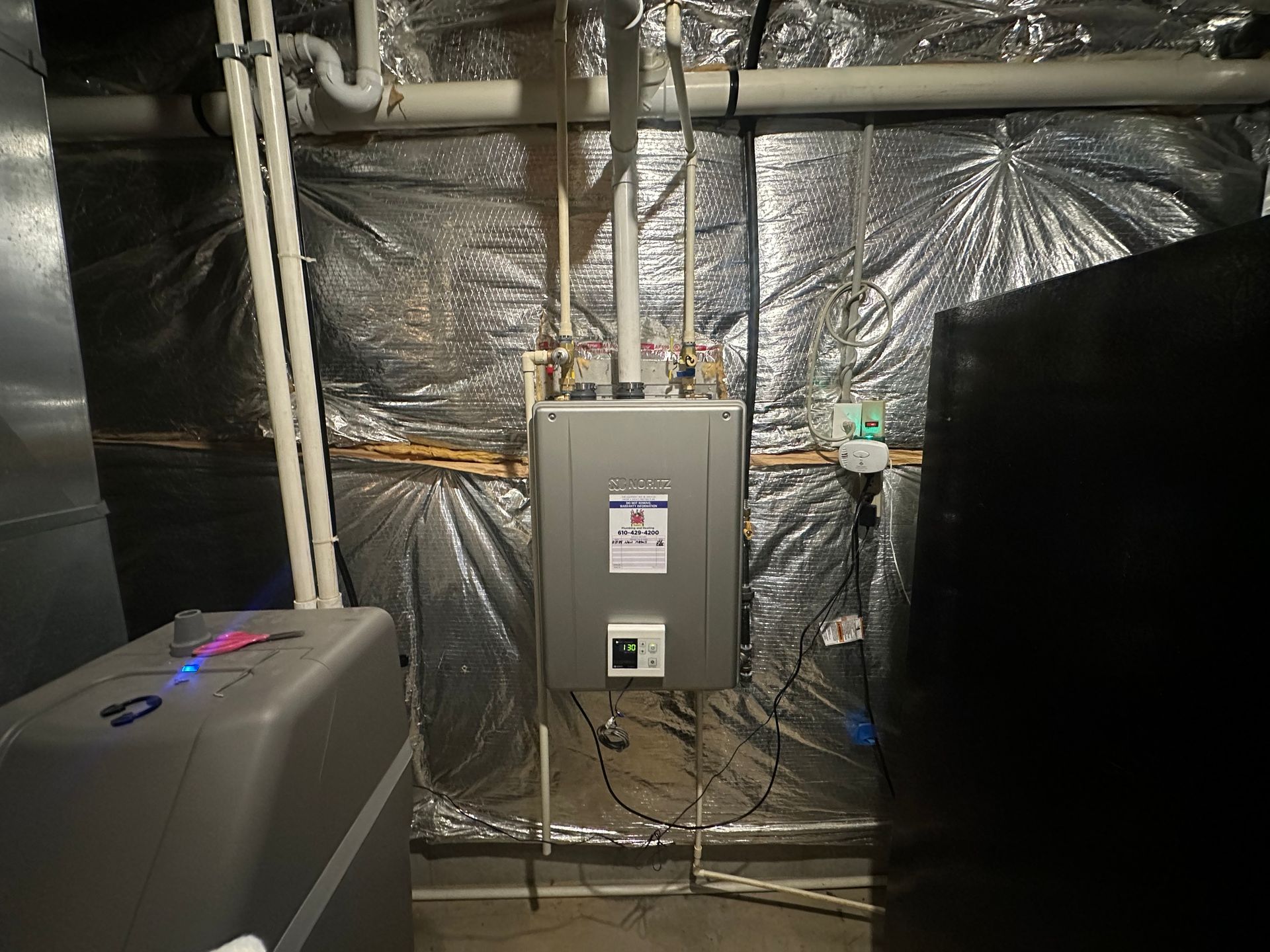 There is a heater in the corner of the room.