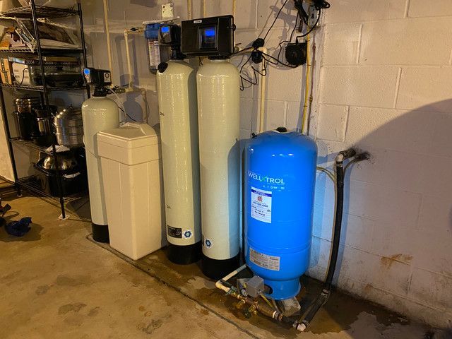 A water treatment system is installed in a basement.