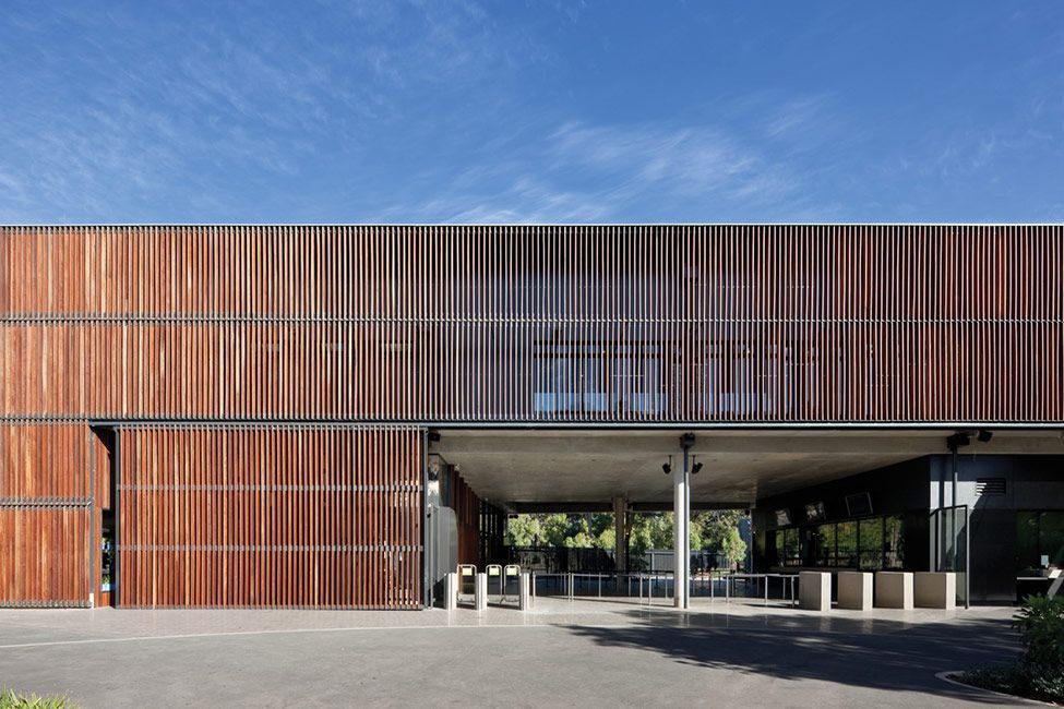 A large building with a lot of windows and a wooden facade.