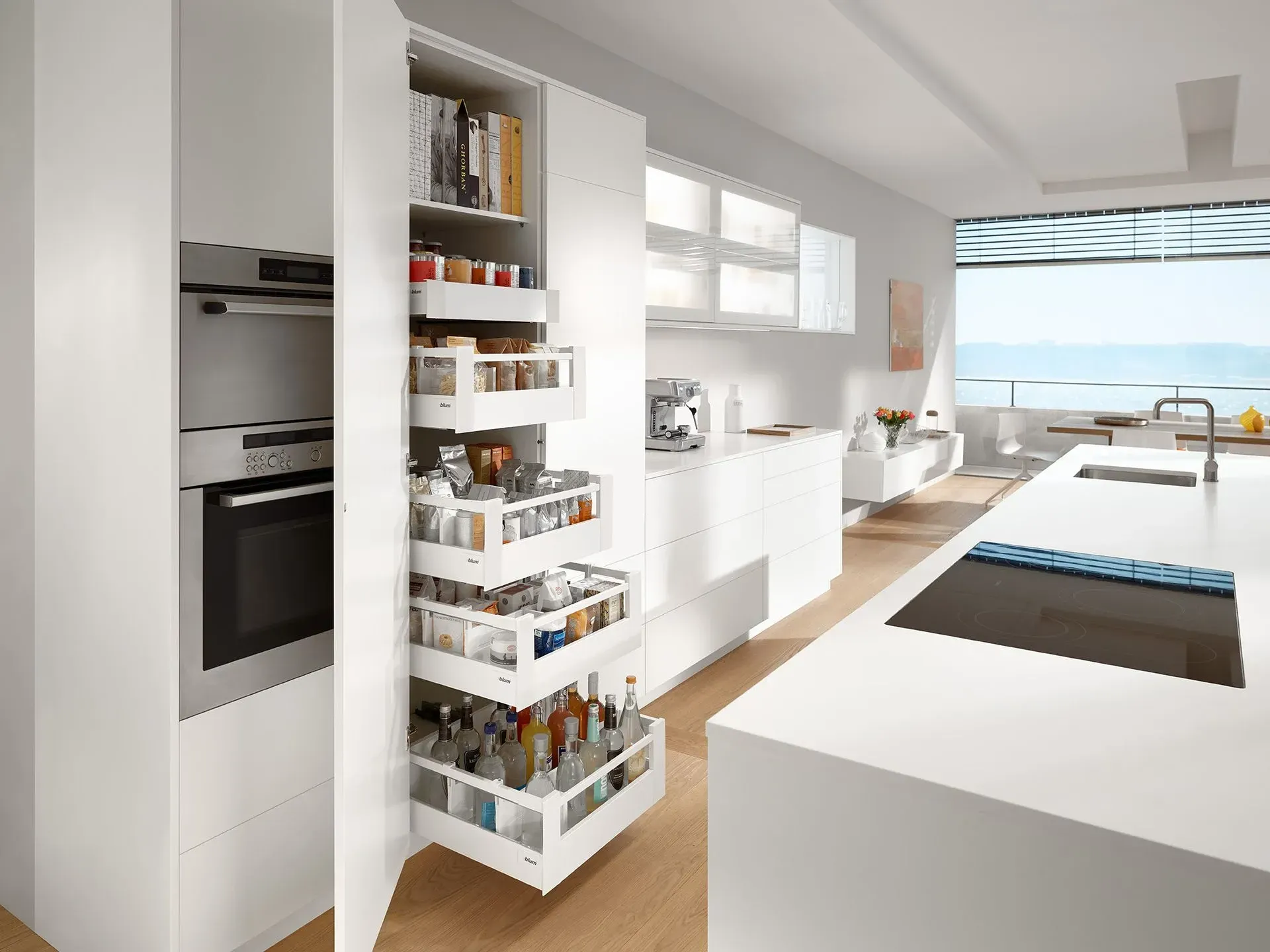 A kitchen with white cabinets , a stove , a sink , and a pantry.