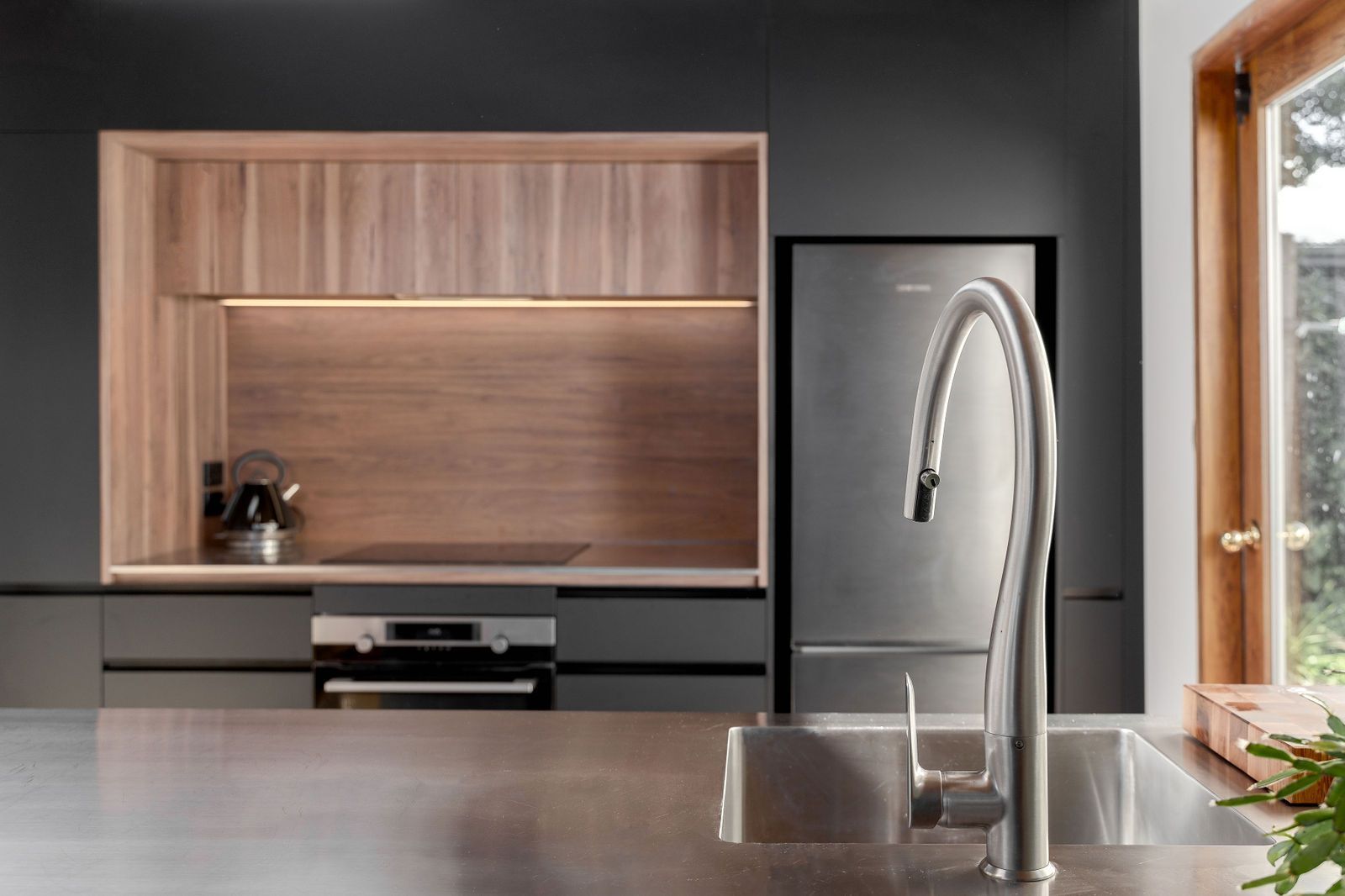 A kitchen with a sink , stove and refrigerator